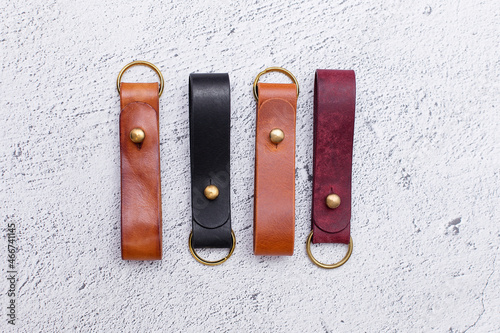 A housekeeper and a keychain made of brown and black leather on a leather backing. top view. Products made of genuine soft leather. Leather accessories for men and women. Handmade work