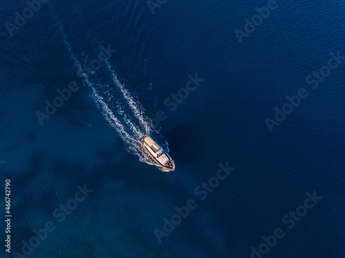Top view from drone of speed boat in the blue water