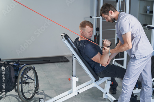 Modern hospital physical therapy of man with handicap in clinic