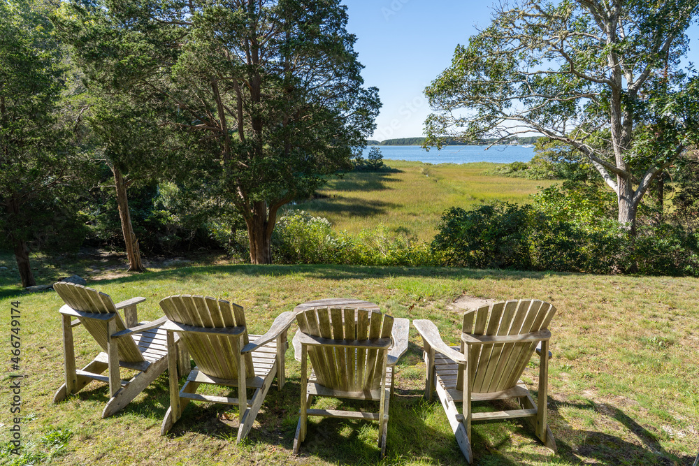 Fototapeta premium Adirondack chairs facing the coastal view in Cape Cod, Massachusetts