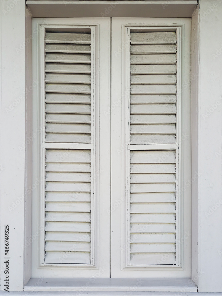 Fototapeta premium Front view of closed white shutter in Caribbean colonial house. Architecture and construction of the French Antilles. Creole style.