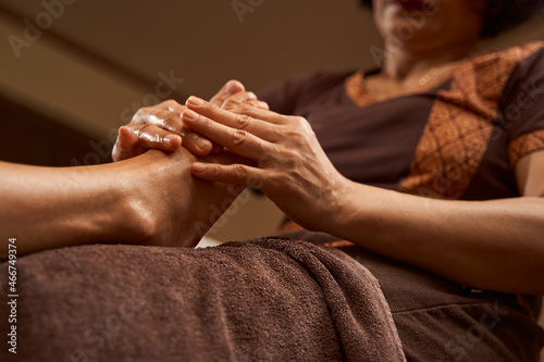 Canvas Print Practitioner massaging client lower extremity using both hands