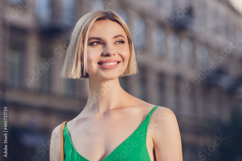 Photo of dream girlfriend blonde cute lady look away toothy smile wear green dress urban city outdoors