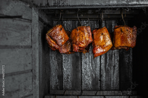 Fresh, delicious smoked, pork meat in smokehouse, smoking process, food concept