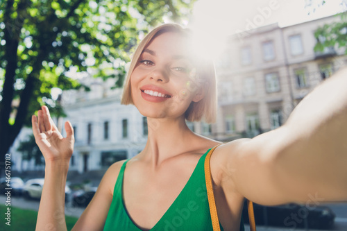 Free Download Photo of adorable sweet young lady wear green outfit handbag smiling walking tacking selfie outside urban city street - GFXLoad