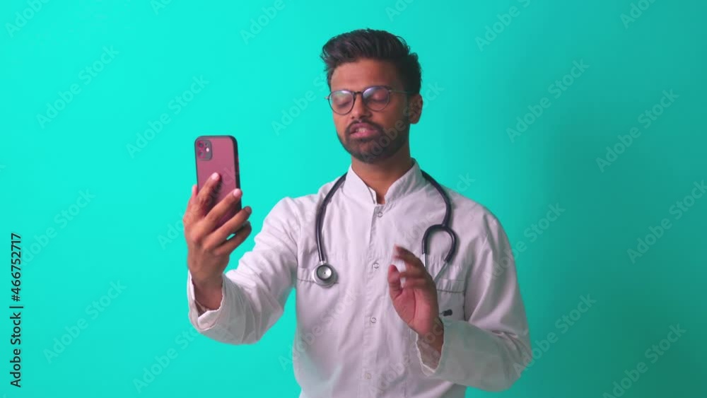 latin hispanic doc talking by video call with patient in blue studio background latin hispanic doc talking by video call with patient in blue studio background