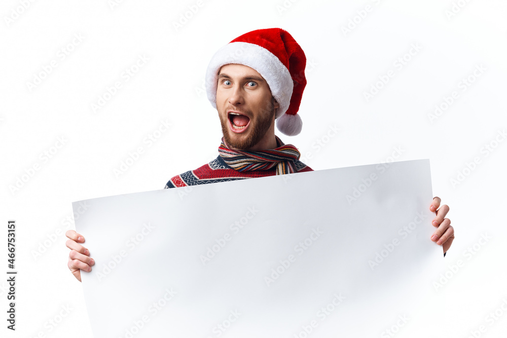 handsome man in a christmas hat with white mockup poster christmas copy-space studio handsome man in a christmas hat with white mockup poster christmas copy-space studio