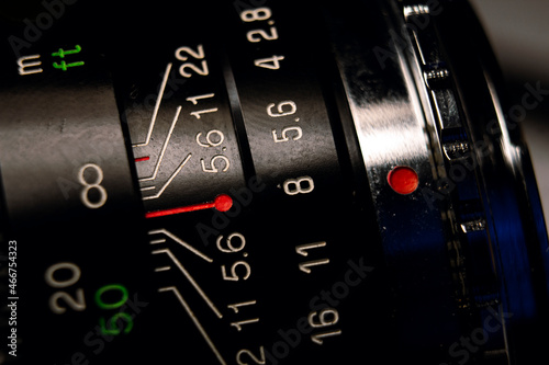 A professional vintage full frame lens' dial with diaphram and focus distance indicators in macro image.  photo