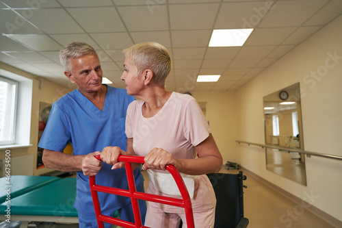 Photo of mature woman with walking disability in rehab center