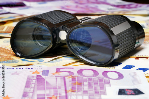 Black binoculars and euro. Currency Cash Money. Security. Discovery, telescope, binoculars. Detective. Forex. Finance expedition. Military. Vintage optic tool                        