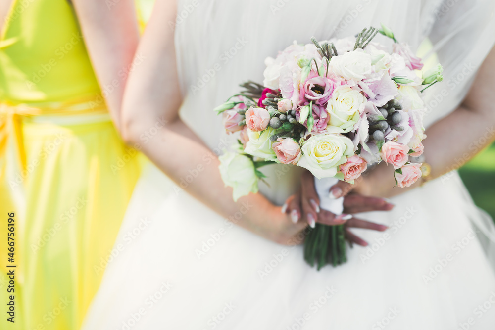 Bride holding big and beautiful wedding bouquet with flowers Bride holding big and beautiful wedding bouquet with flowers