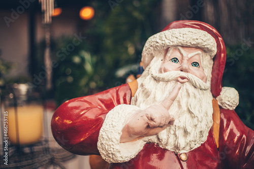 A plastic Santa statue with a hush gesture. An outdoor novelty christmas decoration. photo