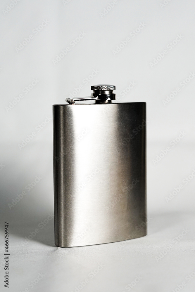 a full view of a metal hip flask for liquor. a stainless flask for complex alcohol that is possible to be put in the hip pocket. a full view of a metal hip flask for liquor. a stainless flask for complex alcohol that is possible to be put in the hip pocket.