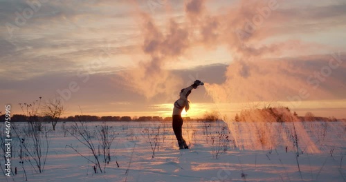 Boiling water challenge woman in bikini throw hot water in freezing winter air