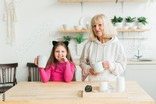 Grandmother and granddaughter having fun together at home. Generation and family concept
