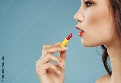 pretty brunette naked shoulders lipstick cosmetics blue background