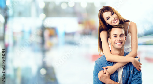 Love, relationship, dating, flirting, lovers, romantic concept - lovely couple, standing close to each other. Copy space for some text. Blurred modern interior or mall background.