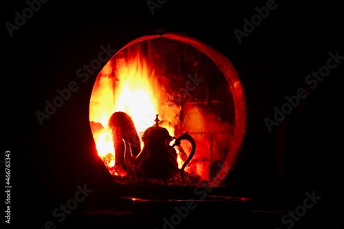 Moroccan tea on fire in the fireplace © Anas