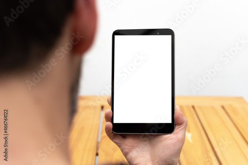 Person looking at a tablet in an upright position with space available