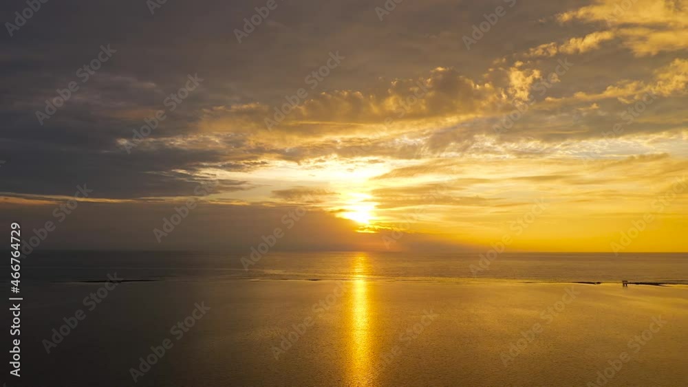 Sky with clouds over the sea during sunrise in cloudy weather, top view. Sunset over ocean. Seascape, Summer and travel vacation concept.