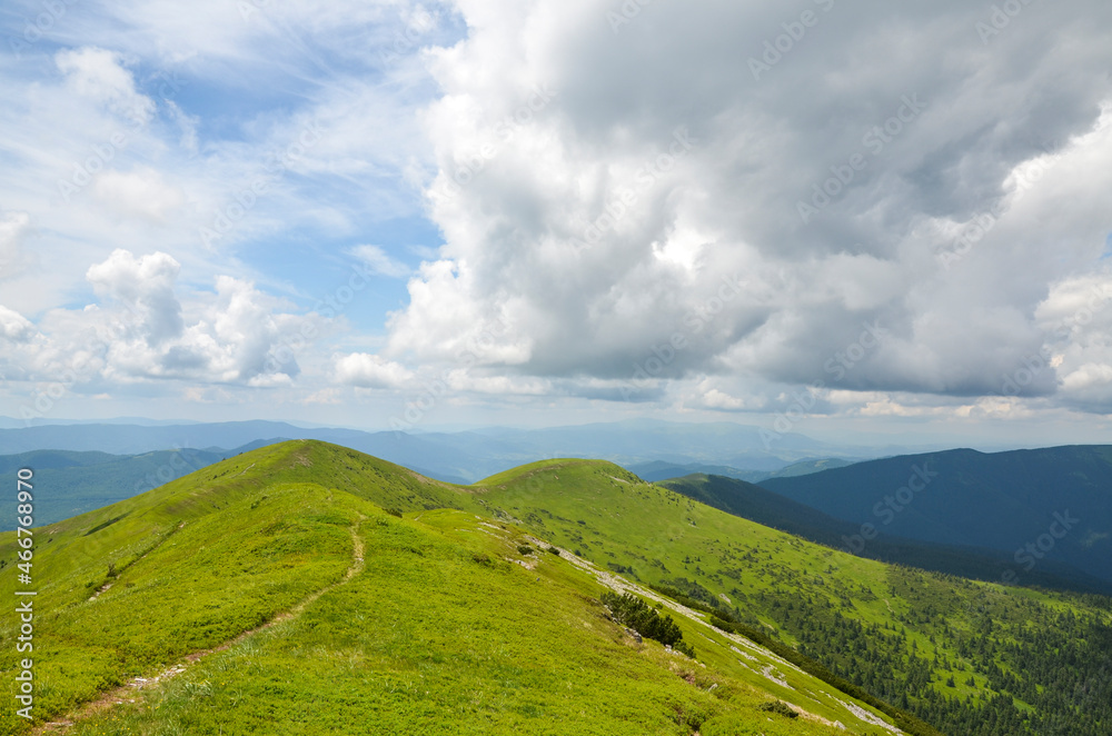 Beautiful Carpathian with hilly mountains. Summer mountains green grass and blue sky landscape