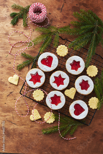 Classic Linzer Christmas Cookies with raspberry or strawberry jam on wooden table photo