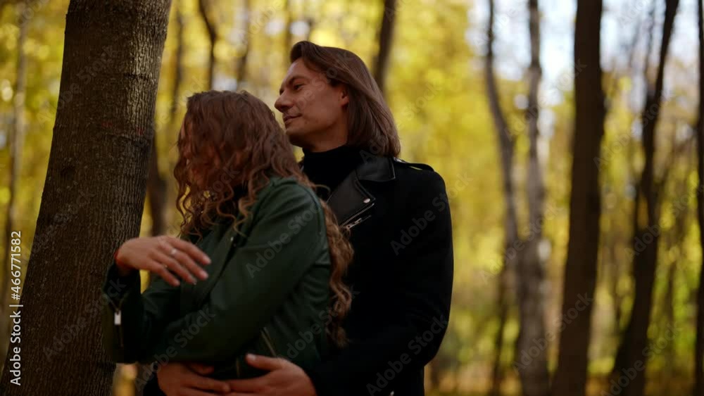 beautiful woman in hugs of her beloved man, love story concept, lovers in park