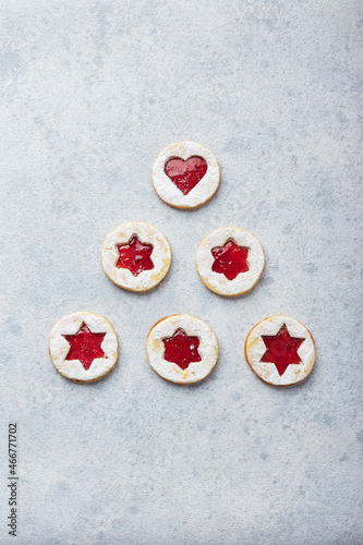 Classic Linzer Christmas Cookies with raspberry or strawberry jam on light background. photo