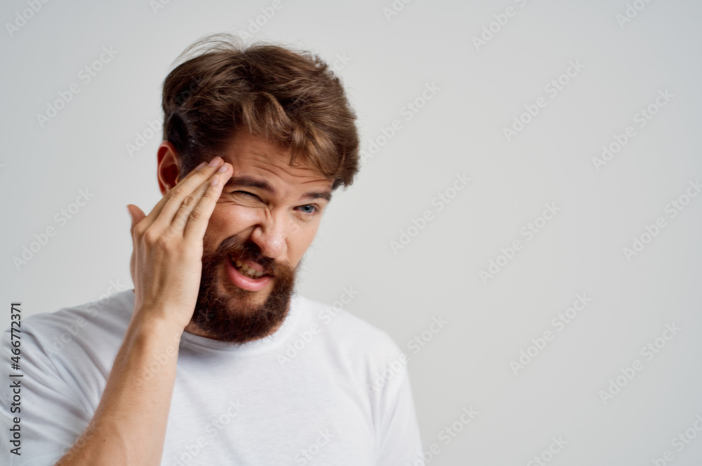 man in a white t-shirt headache migraine problems Studio treatment man in a white t-shirt headache migraine problems Studio treatment