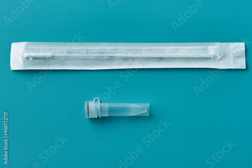 Virus testing swab and test tube on a blue background. Prevention viral infection Covid-19. Concept medicine health care