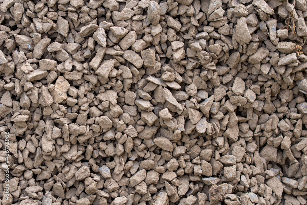 The texture of dirty rubble. Background of small stone covered with mud The texture of dirty rubble. Background of small stone covered with mud