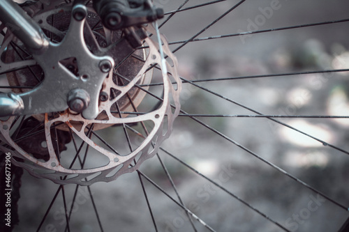 Bicycle elements in close-up. Individual parts of a sports bike are in focus. The vehicle parts are covered with dust