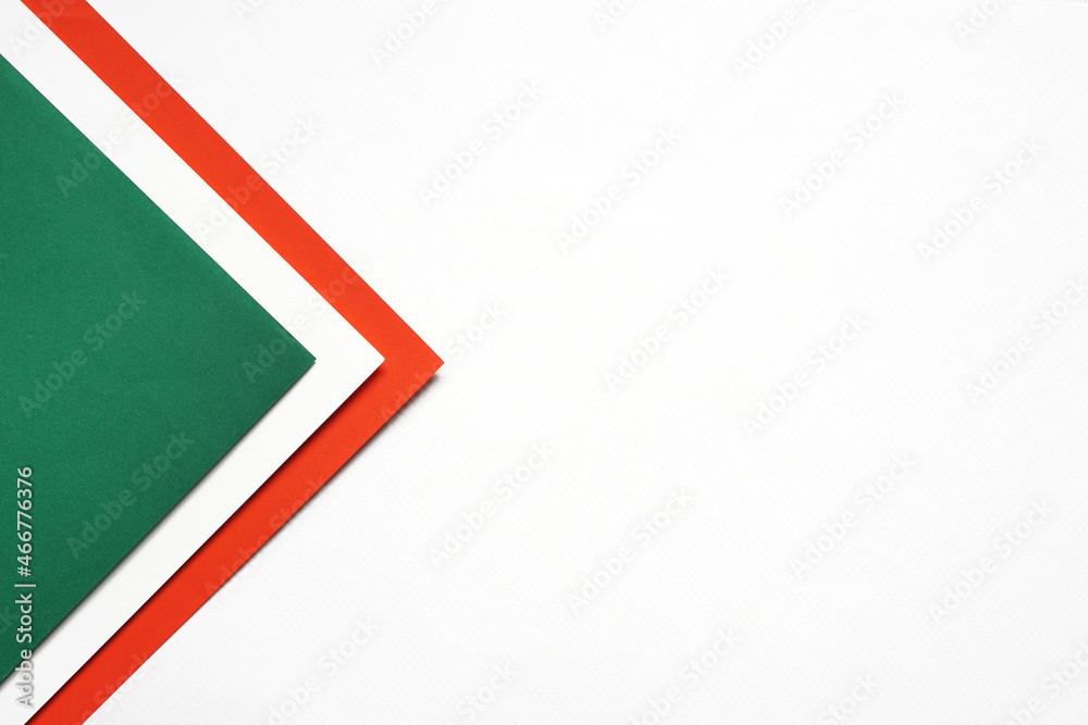 On a white background, an abstract background concept with a geometric pattern of blank green and red paper stacking. On a white background, an abstract background concept with a geometric pattern of blank green and red paper stacking.