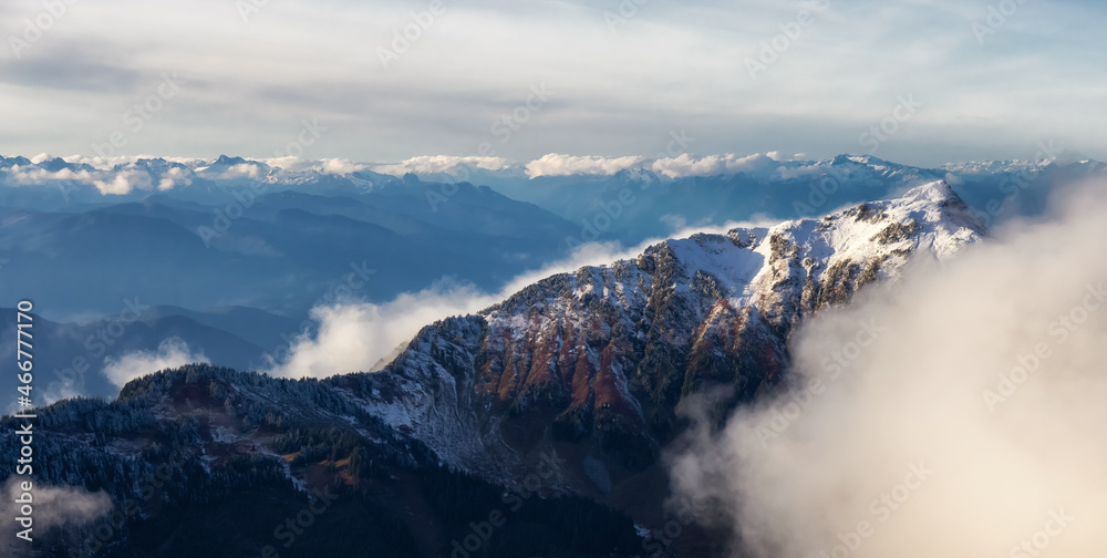 Aerial View of Canadian Rocky Mountains with snow on top during Fall Season. Nature Landscape located near Chilliwack, East of Vancouver, British Columbia, Canada.