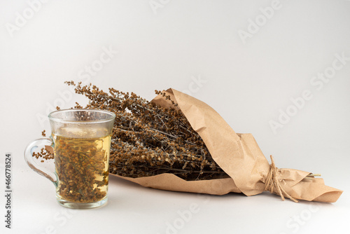 Herb tea and Wormwood twigs wrapped in brown paper. photo