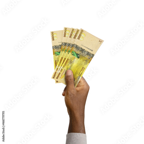 Konstfotografi Black Hand holding 3D rendered Ugandan shilling notes