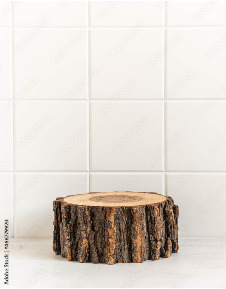 Fototapeta premium Round natural wooden podium mockup for eco, food or beauty product on white tile background.