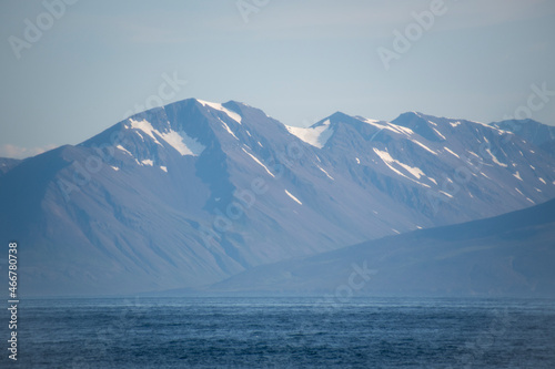 Landscape of snow covered mountains in fjord in North Iceland