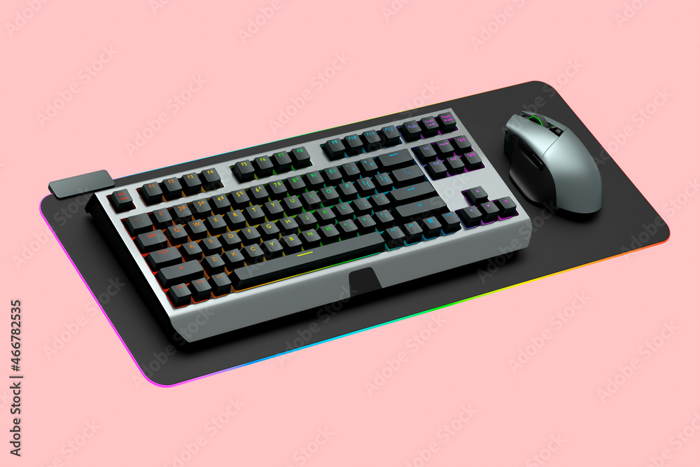 Computer keyboard and silver mouse on professional pad isolated on pink