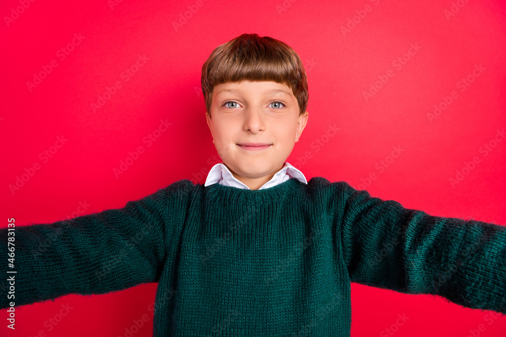 Photo of handsome pretty schoolboy dressed green sweater recording self video smiling isolated red color background Photo of handsome pretty schoolboy dressed green sweater recording self video smiling isolated red color background