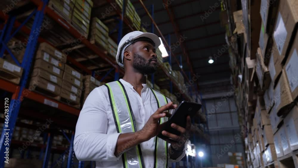 Business concept of 4k Resolution. An employee is checking the goods with a tablet in the warehouse. Business concept of 4k Resolution. An employee is checking the goods with a tablet in the warehouse.
