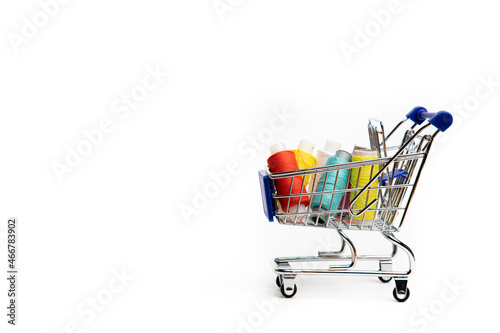 Trolley with thread on a white background . Thread selection. Shopping for needlework. White background.