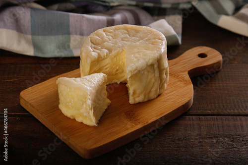 Fresh and creamy french cheese on a rustic background