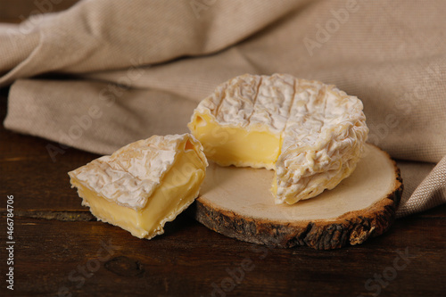 Saint-Marcellin soft French cheese on a rustic background