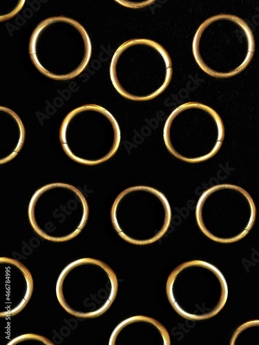 Pattern from metal copper rings on black background 