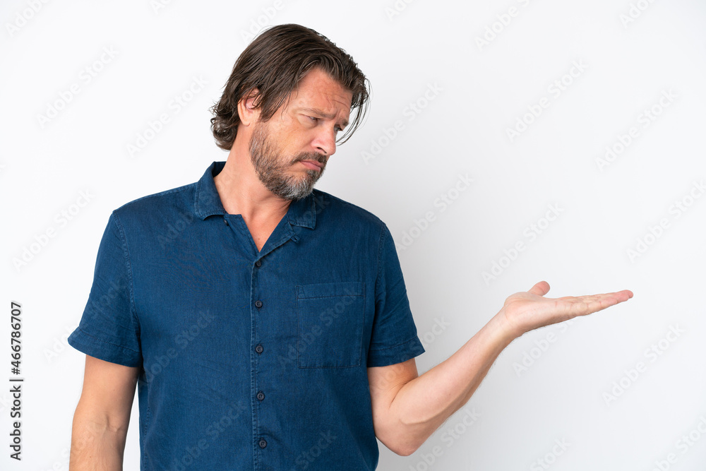 Senior dutch man isolated on white background holding copyspace with doubts Senior dutch man isolated on white background holding copyspace with doubts