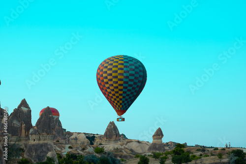 Hot air balloon taking off and fairy chimneys in Cappadocia