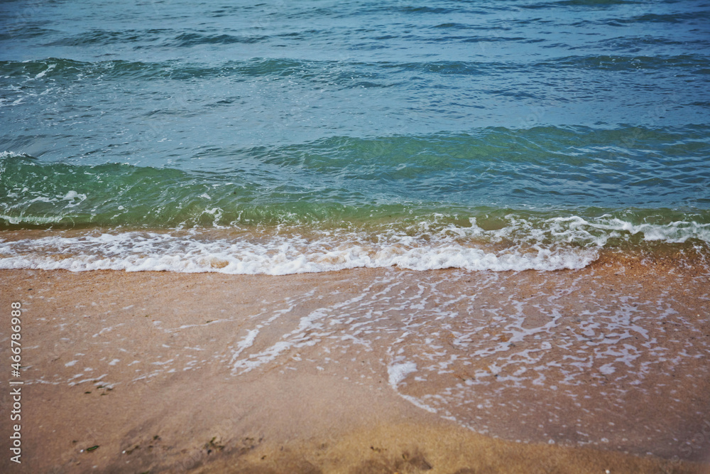 Clean and relaxing sea wave splashes over seashore. Coral beach of tropical paradise. Idyllic seascape for beach wedding or honeymoon. Exotic seaside banner . Caspian Sea sea water over white sand Clean and relaxing sea wave splashes over seashore. Coral beach of tropical paradise. Idyllic seascape for beach wedding or honeymoon. Exotic seaside banner . Caspian Sea sea water over white sand