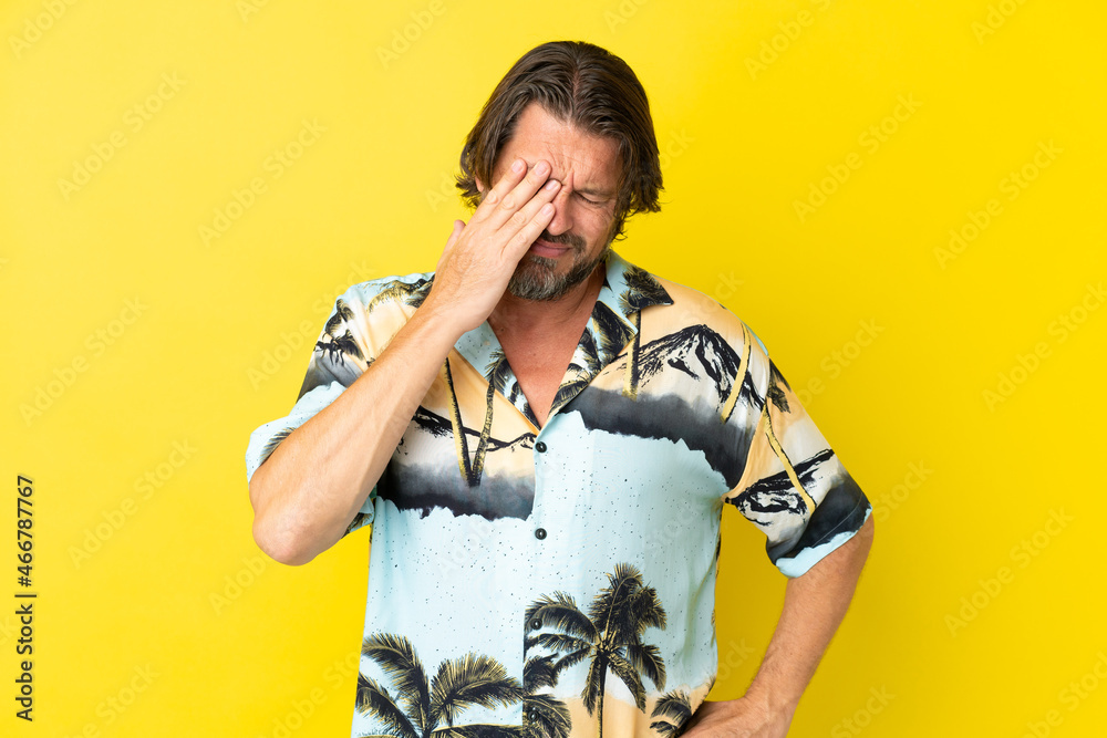 Senior dutch man isolated on yellow background with headache Senior dutch man isolated on yellow background with headache