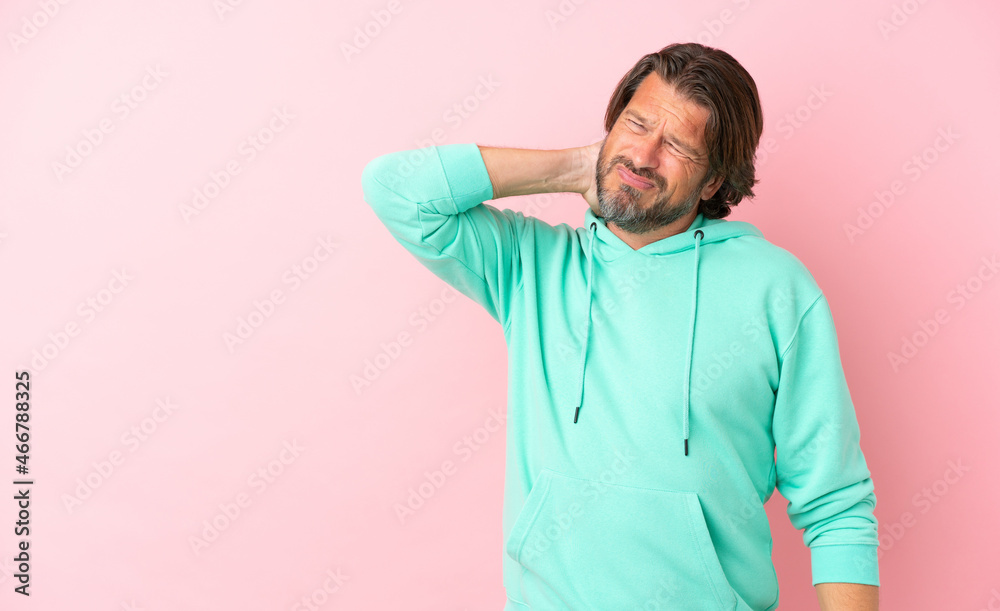 Senior dutch man isolated on pink background with neckache Senior dutch man isolated on pink background with neckache